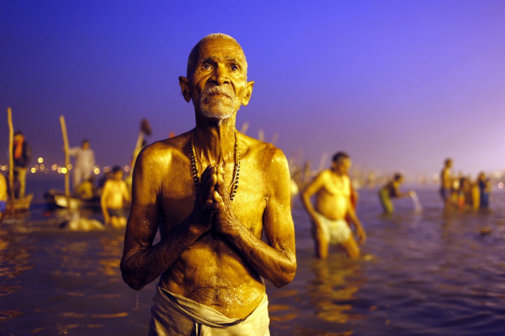 A Hindu devotee prays after a holy dip at the Sangam, the confluence of three holy rivers -- the Ganges, the Yamuna and the mythical Saraswati -- during the Kumbh Mela festival in Allahabad, India, on Sunday