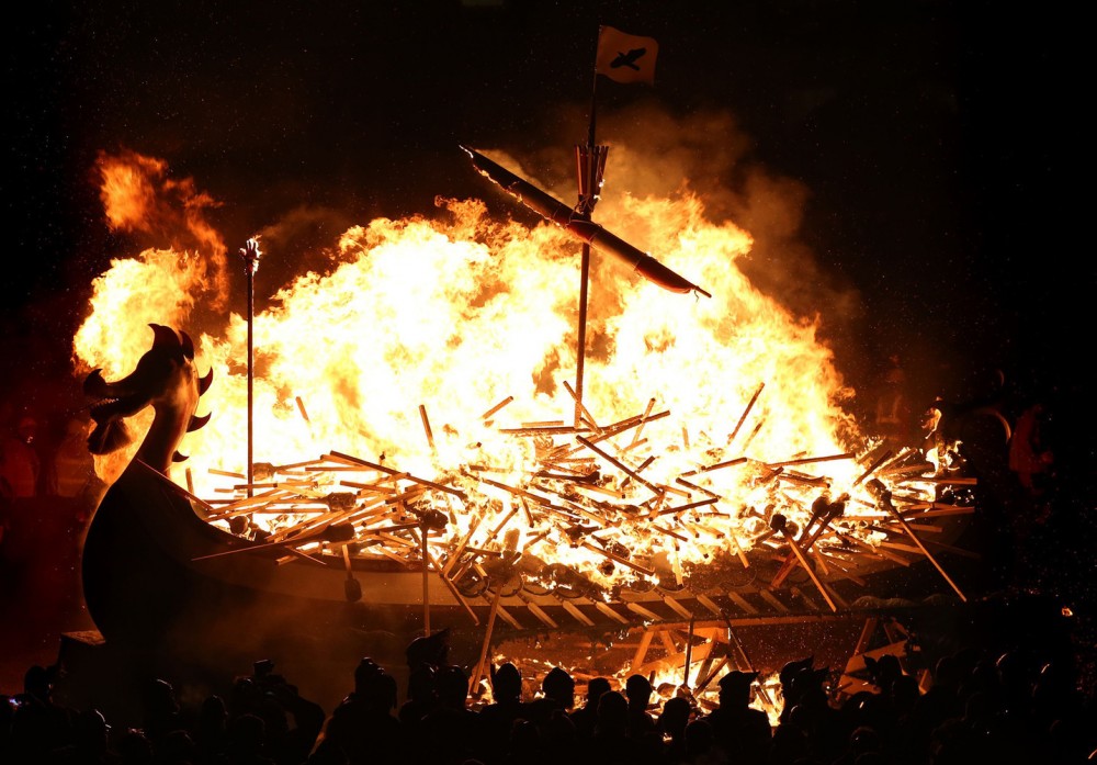 Up Helly Aa festival 2016. The Galley is burned by Guizer Jarl Mark Evans and members of the Jarl Squad, during the Up Helly Aa Viking festival in Lerwick on the Shetland Isles. Picture date: Tuesday January 26, 2016. Originating in the 1880s, the festival celebrates Shetland's Norse heritage and sees a 'Viking longship' dragged through the streets of Lerwick, led by a horde of people dressed as Vikings before being set alight. Photo credit should read: Andrew Milligan/PA Wire URN:25347738